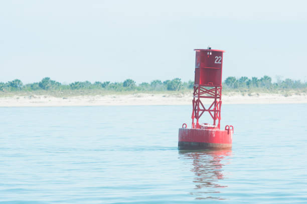 Red Nautical Channel Marker by Cumberland Island Florida In Cumberland Island, United States on a spring morning a red channel marker floats in the Atlantic Ocean water off the coast of Cumberland Island. near the state borders of Florida and Georgia. channel marker stock pictures, royalty-free photos & images