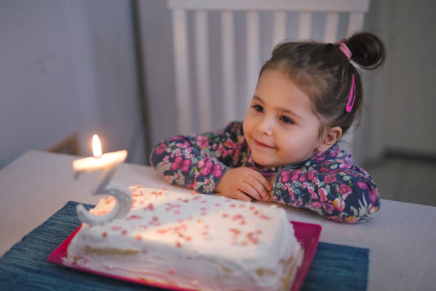 istock Cute girl looking at the candlelight 946617096