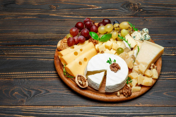 istock various types of cheese on wooden cutting board 946617408