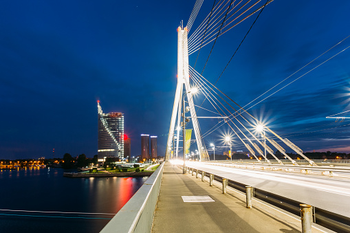 Riga Latvia. Close View Of Deserted Vansu Cable-Stayed Bridge In Bright Night Illumination, Blue Sky