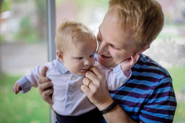 istock Father holding his baby boy 946621384