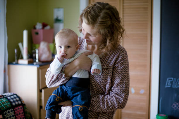 istock Mother holding her baby boy 946623160