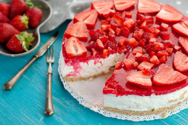 istock Fresh red fruit strawberry cake on wooden background 946624660