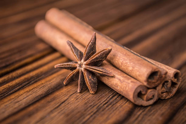 istock Dried anise star and cinnamon sticks on a wooden background 946628486