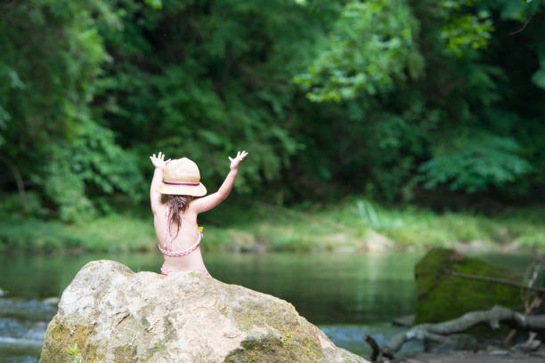 istock Little girl playing on a stream 946632154