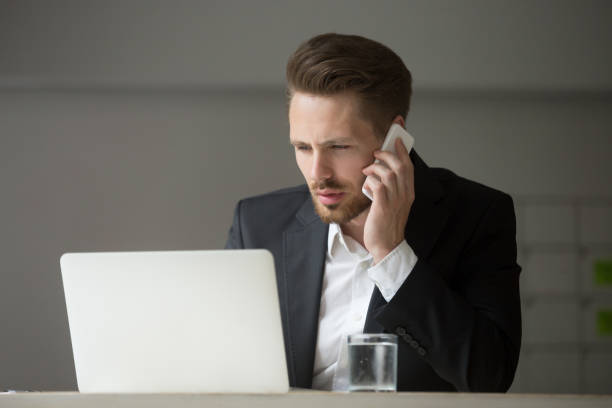 istock Concentrated CEO discussing financial problems on the phone 946636852