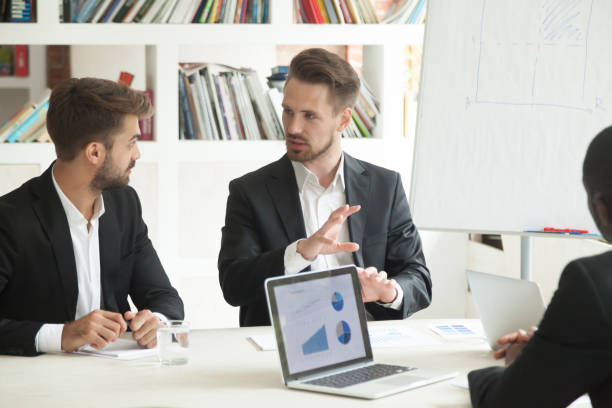 istock Business worker sharing thoughts with male coworker 946636954