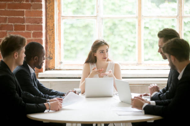 istock Female CEO explaining business strategy to male subordinates 946636980
