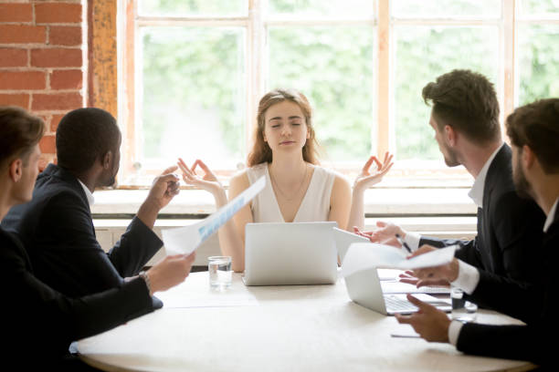 istock Female leader meditating ignoring angry coworkers 946636990