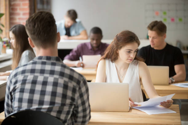 istock Concerned female reading paper report in coworking space 946637074