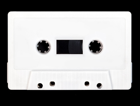 Vintage white audio cassette tape on a black background.