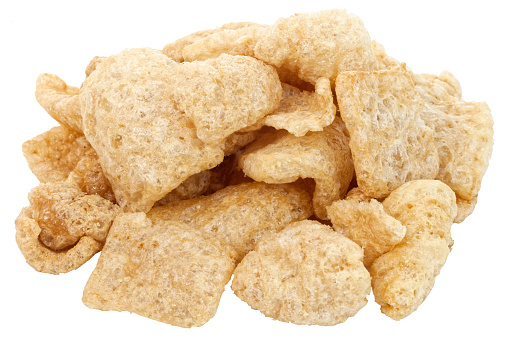 Isolated pile of pork rinds or chicharones.