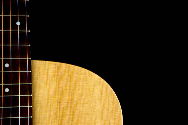 istock Acoustic Guitar Partial Body and Fingerboard on Black 946651546
