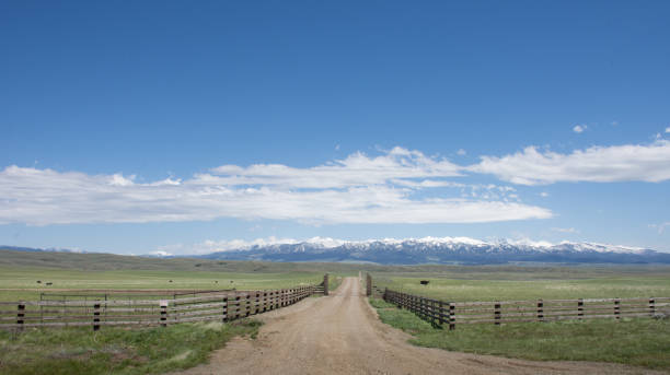 istock Expansive Ranch Land with a Country Road 946662556