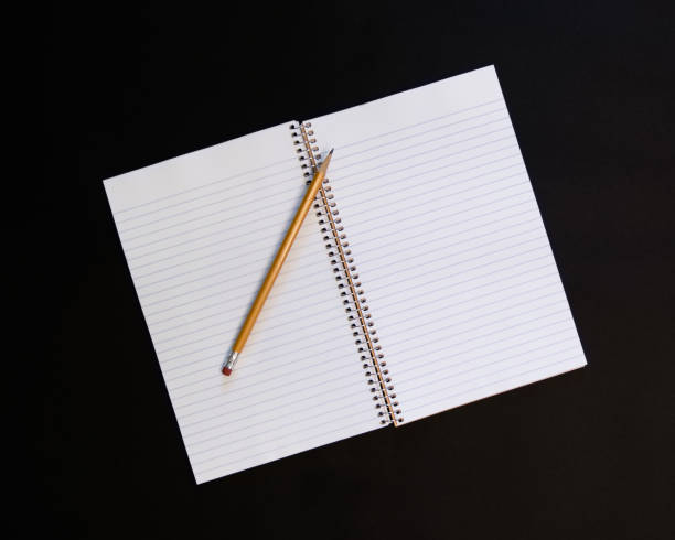 istock Pencil and Paper on black background 946665766