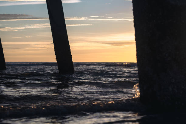 istock woman on the beach at sunrise 946665788