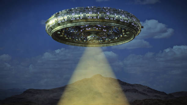 istock UFO, alien spaceship with light beam hovering in the night sky, extraterrestrial visitors with flying saucer 946669752