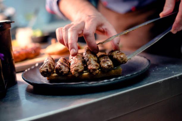 istock Man's hands preparing burgers 946675614