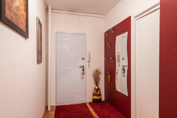 istock Red and white interior of apartment corridor 946675772