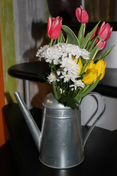 istock flowers watering can still life 946678940