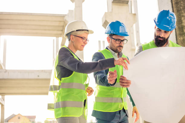 istock Group of architects or business partners having meeting on a construction site 946681668