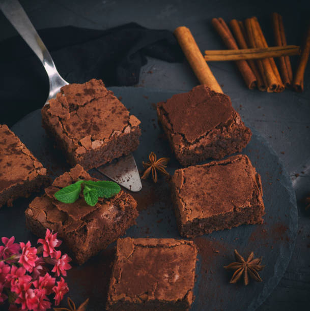 istock pieces of chocolate brownie on a black round graphite plate 946686146