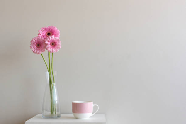 istock Tall pink gerberas with pink mug 946692886