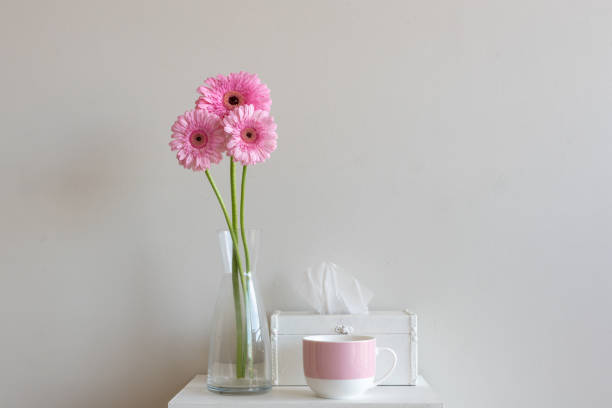 istock Tall pink gerberas with tissue box and pink mug 946693108