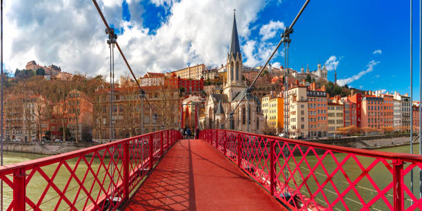 Saint Georges church and footbridge, Lyon, France Panoramic view of Saint Georges church and pedestrian footbridge across Saone river, Old town with Fourviere cathedral in the sunny day in Lyon, France lyon photos stock pictures, royalty-free photos & images