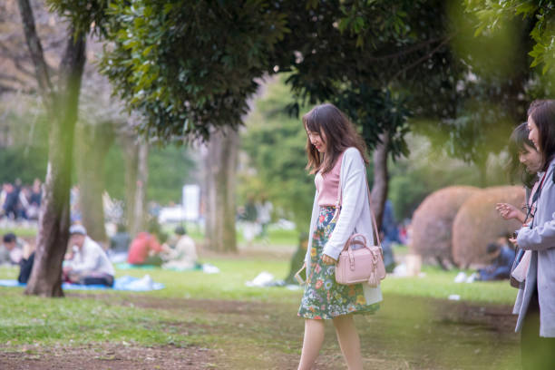 istock Young female friends strolling in public park 946696134
