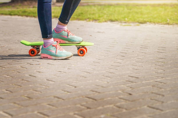 istock Girl on a skateboard in the Park. 946710540