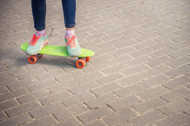 istock Girl on a skateboard in the Park. 946710578