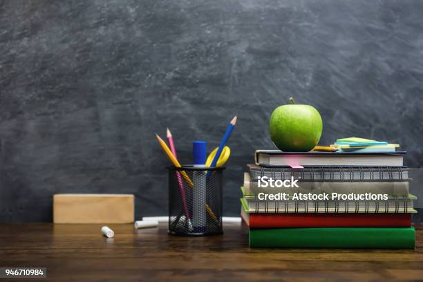 Books Stationery And Education Supplies On Wooden Desk In Classroom Stock Photo - Download Image Now