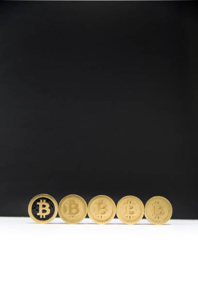 istock Row of bitcoins on black and white background 946715940