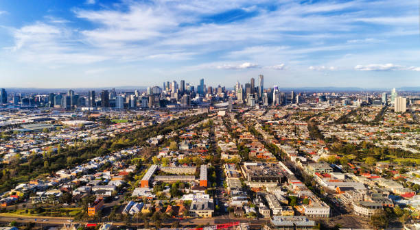 D Me Port 2 CBD Midair Leading streets and residential suburbs from Port Melbourne via Southbank to Melbourne city CBD against blue sky in aerial wide view. victoria australia photos stock pictures, royalty-free photos & images