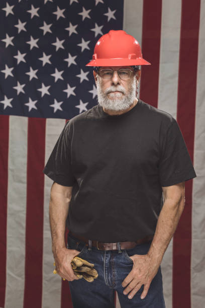istock Handsome American Construction Worker with American Flag 946735056