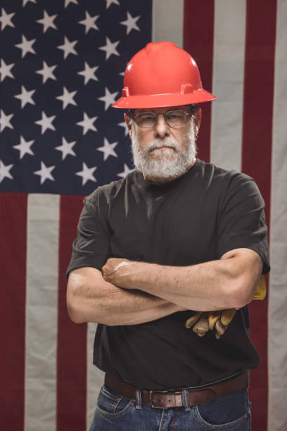 istock Handsome American Construction Worker with American Flag 946735072