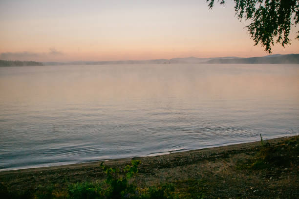 istock gentle soft light pink dawn on the big lake, sunrise 946737852