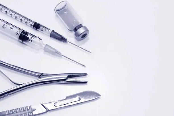 The Surgical Instruments,  Vial of Drug and Plastic Syringe with Needle   Isolated on the White Background