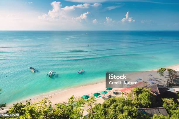 Tropical Blue Ocean Sandy Beach And Boats In Indonesia Bali Stock Photo - Download Image Now