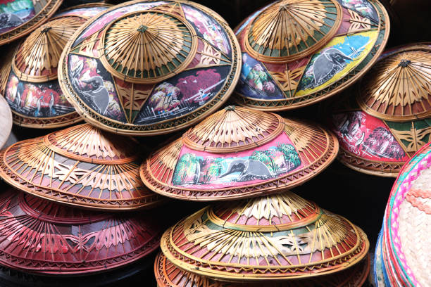montón de sombreros tailandeses tradicionales que son pintados con escenas rurales y de bambú, phuket, tailandia. - selling merchandise craft thailand fotografías e imágenes de stock
