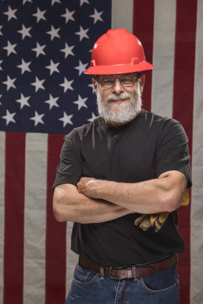 istock Handsome American Construction Worker with American Flag 946745080