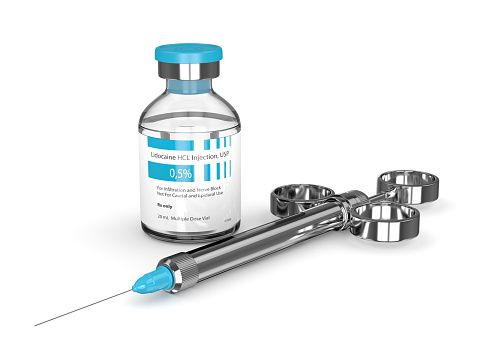 3d render of lidocaine glass vial with syringe isolated over white background. Dental anesthesia concept. Lidocaine is an organic chemical compound used as a local anesthetic