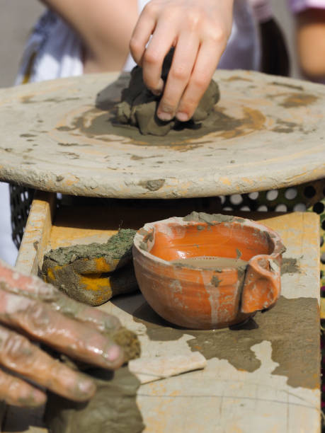istock Senior teacher works clay with young students 946768886