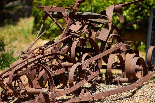 istock Old Abandoned Farm Equipment Left to Rust in Field 946769546