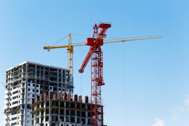 istock High-rise buildings under construction and building cranes 946777028