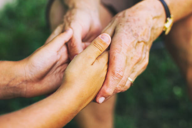 istock Old senior female hands and children's hands 946777740
