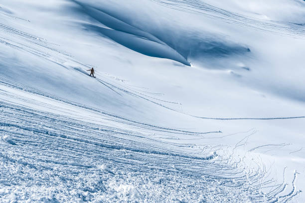 istock A snowboarder descends the mountainside. 946780664
