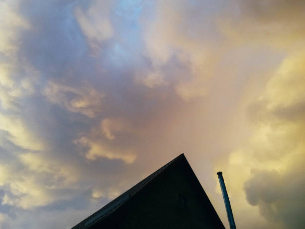 istock Thunderstorm clouds over suburban house 946780860