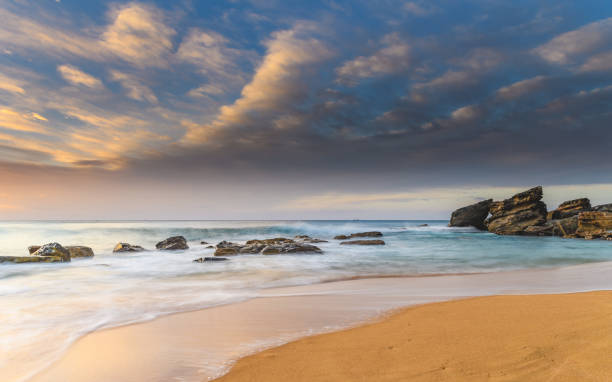istock Rocky Sunrise Seascape with Clouds 946784370